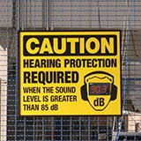 A decibel status sign. It shows the current noise level in decibels, and it says "Caution - Hearing protection required when the sound level is greater than 85 decibels."