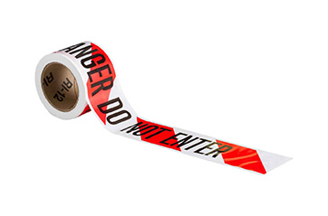 A roll of white and orange striped barricade tape.