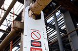 A white Brady Scafftag is equipped to scaffolding to indicate the danger of this particular scaffolding.