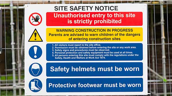 A construction site safety sign outlines key safety elements when entering the jobsite.