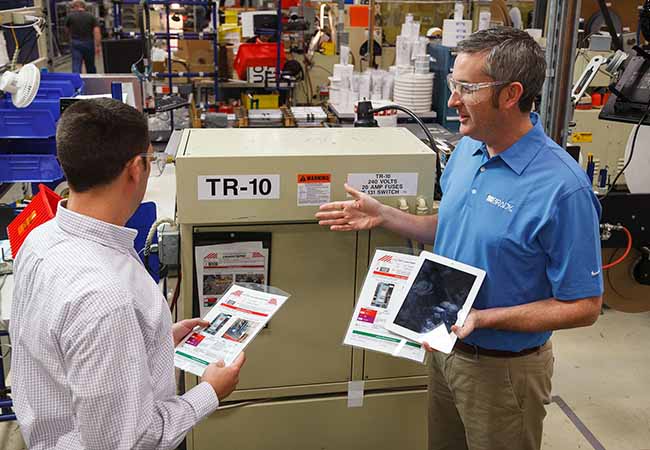 Two employees walking through an LOTOTO training course to ensure their knowledge is up to date.