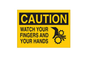 A yellow sign that says "CAUTION WATCH YOUR FINGERS AND HANDS."