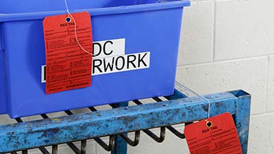 Printed tags identifying the contents of bins.