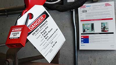 A printed tag attached to a padlock.