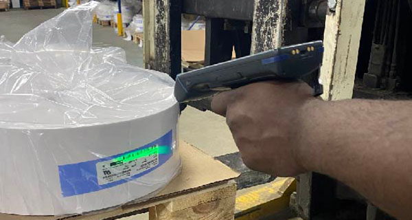 Worker using a Brady RFID reader to scan and track a product.